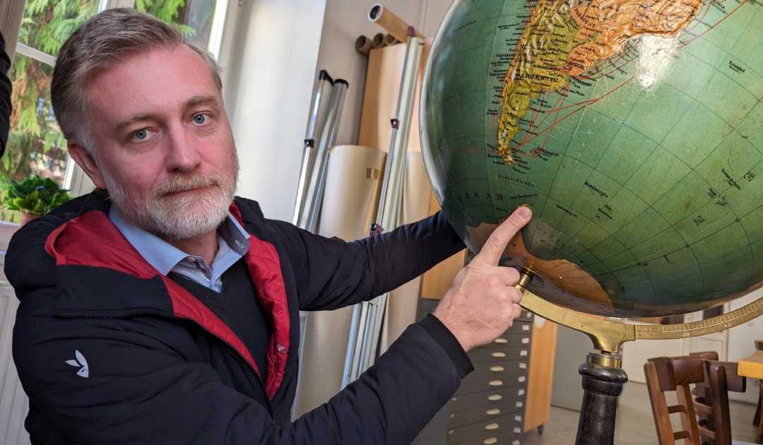 In the old map room of the Masaryk University’s geographical department, Daniel Nývelt, Head of the Programme, is showing the location of Czech Antarctic Research Programme’s Antarctic base. Photo: Ole Ellekrog