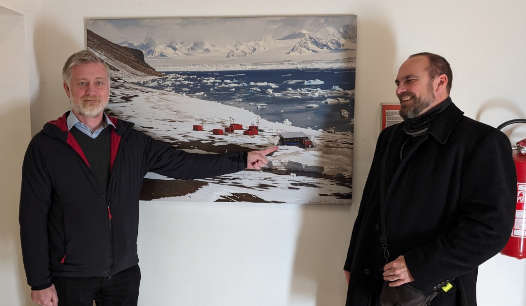 On this day in January, Daniel Nývelt, Head of the Programme, (left) and Pavel Kapler, Chief of Operations, are the only people left in Brno. Daniel Nývelt is pointing to a photo of the Mendel Polar Station. Photo: Ole Ellekrog